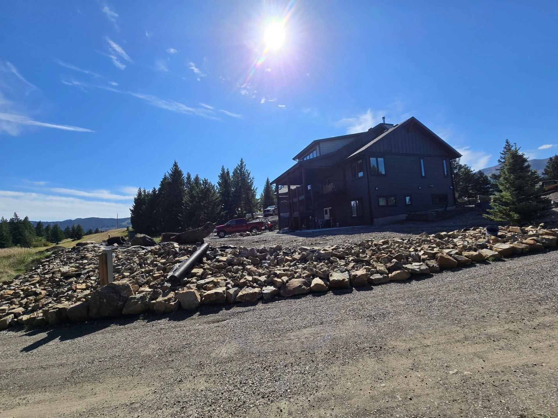 Boulder retaining wall below a home
